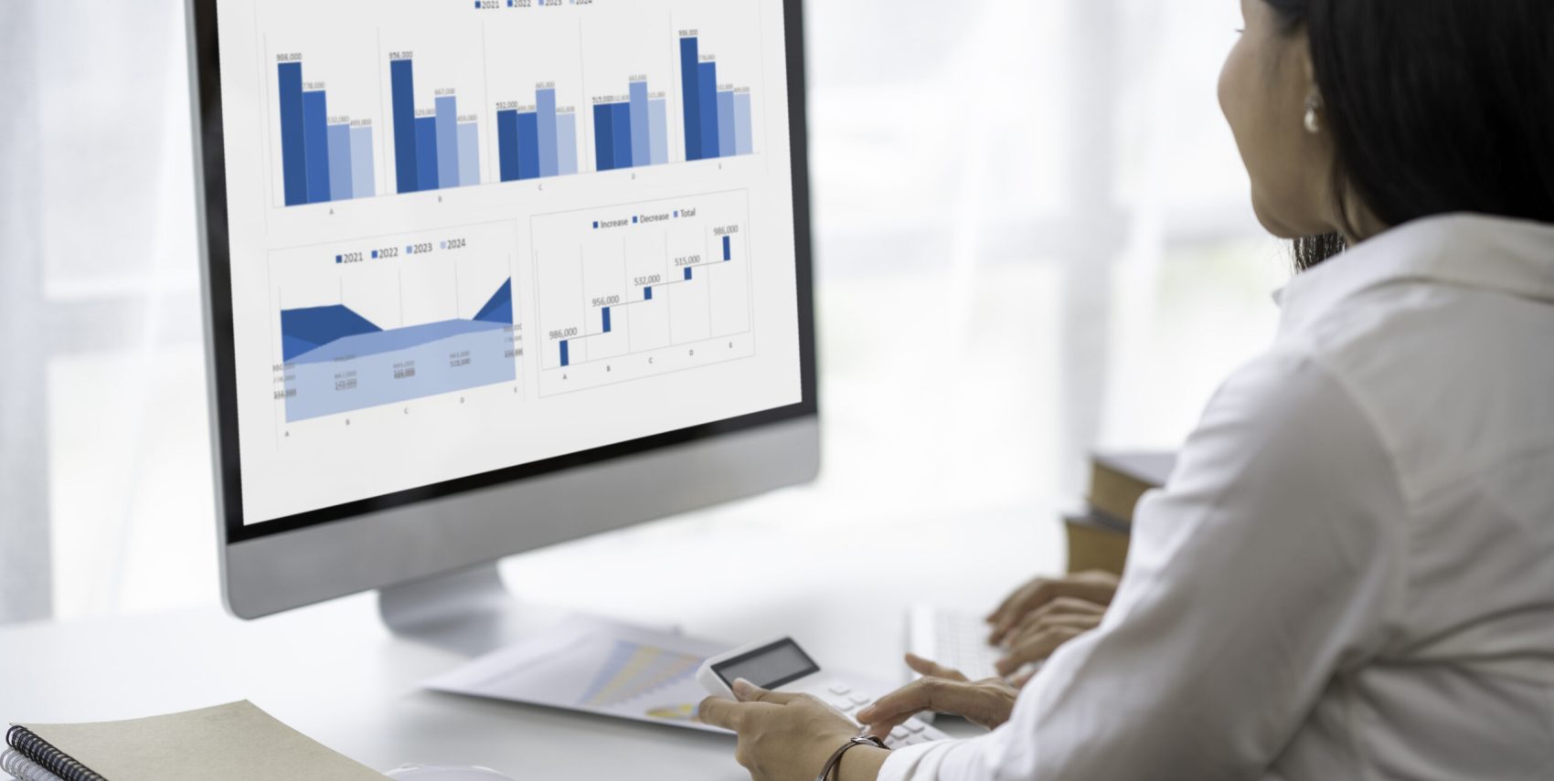 two young Asian businesswomen using their documents and calculators to plan marketing strategies and investments to profit from their clients,finance and calculate concept